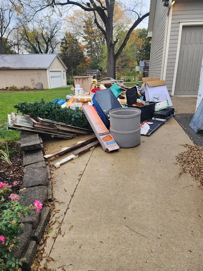 Dumpster being loaded with debris for 12 Yard Dumpster Rental in Laketon
